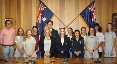Members of youth council standing in front of Australian flags