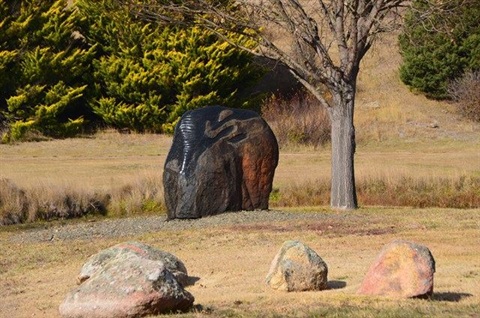 Sculpted basalt rock public art titled Dignity and Permanence’