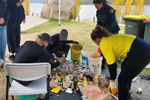 A group of people sorting collected litter at the April 2023 Jindabyne Community Cleanup