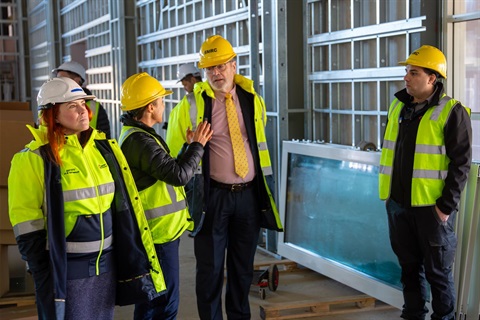 People in high vis gear touring the under-construction Cooma Regional Sports Centre