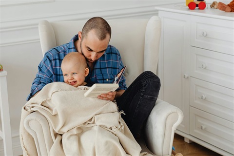 Father reading to infant child