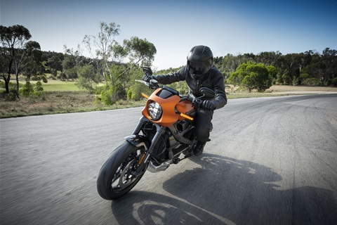 A motorcyclist riding on the road in full protective gear