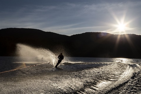 Silhouette photograph of water skiiers on Lake Jindabyne